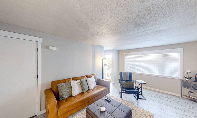 North Bend Condo | Renovated condo with covered porch, grill, & private washer/dryer