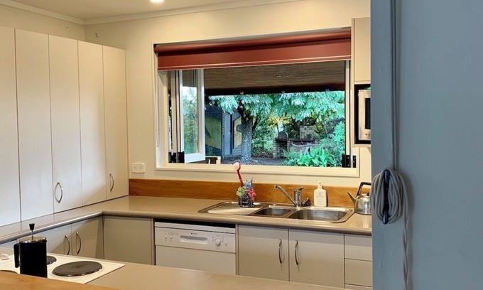 Broadlands Forest House | Riverside accommodation which is perfect for groups. Pizza oven, covered deck.