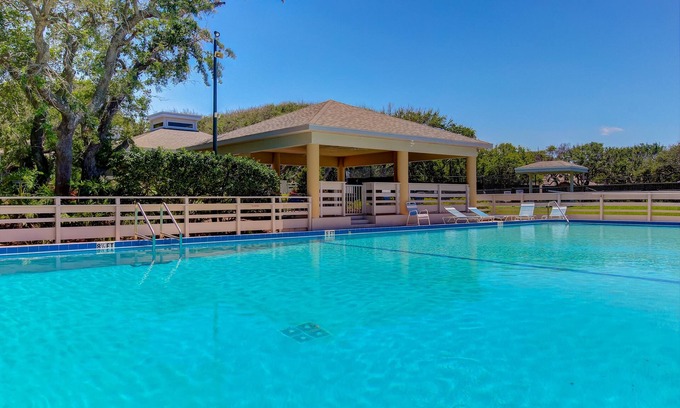 New Smyrna Beach Villa | Row-end condo with pool, clubhouse, tennis, & walk to beach