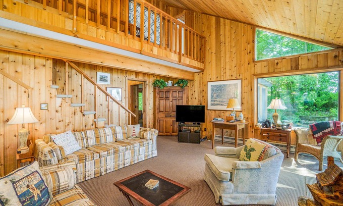 Lake Township House | Rustic dream-home w/lake views, wraparound deck, & wood-burning fireplace