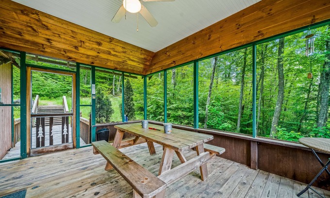 Brant Lake House | Secluded cabin with dock, wraparound deck, gorgeous view & enclosed porch
