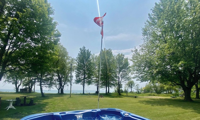 Lowbanks Cottage | Secluded Lakeview w/ hot tub & volleyball net on Lake Erie (Pet-Friendly!)