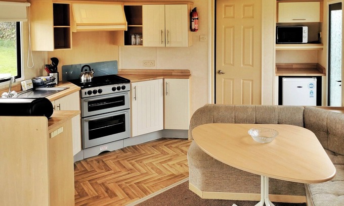 Llanllwchaiarn House | Spacious and comfortable 12ft-wide caravan with one double and two twin.