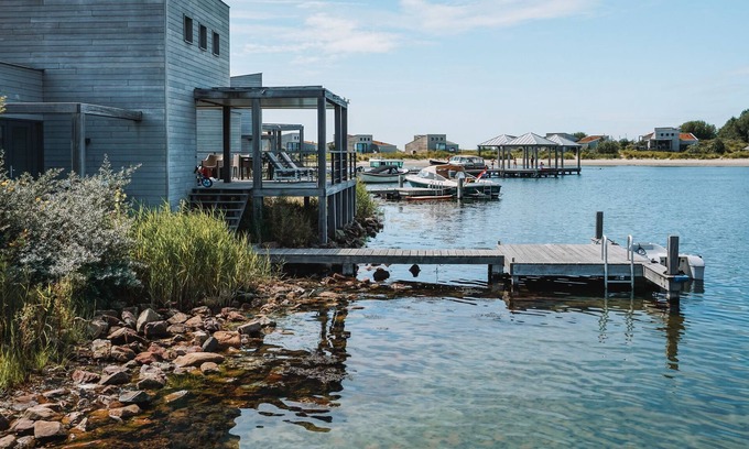 Ouddorp Cabin | Spacious beach villa with private swimming jetty and a terrace on the water.