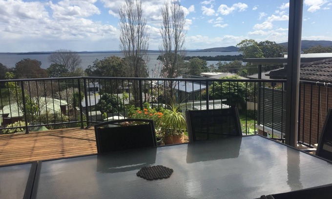 Soldiers Point House | Spacious covered balcony overlooking Sunset beach. Large garden and water views