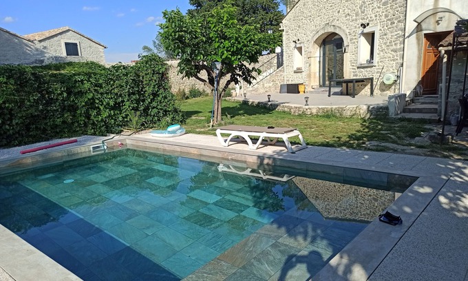 Fontanes House | Stone house renovated in a contemporary style with garden and swimming pool.