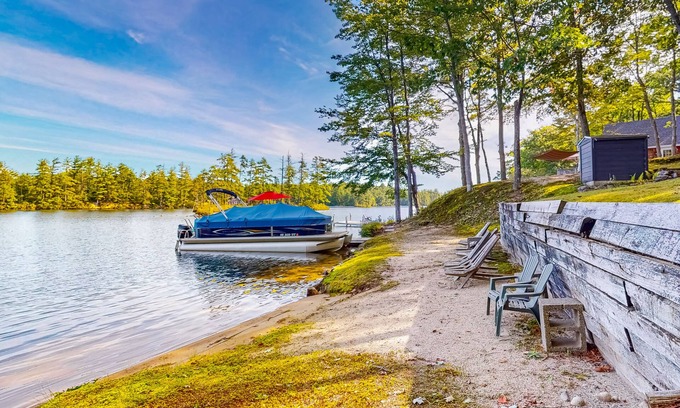 Pine River Pond House | Stunning lakefront home with private dock, deck, firepit, and lake view