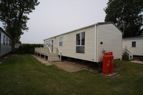 Heacham Ski Chalet | Stunning river view 2 bedroom caravan with decking