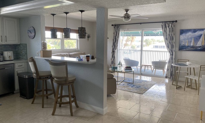 Capri Isle Apartment | "Stunning Waterfront Apartment on Treasure Island with Dock"