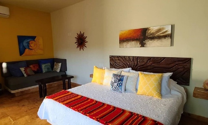 Isla Mujeres Apartment | The Sol Studio Suite with balcony overlooking the pool and garden area