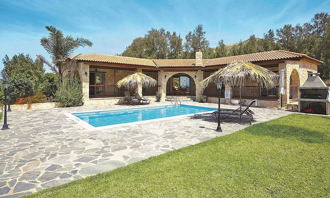 Pomos House | This attractive stone villa is set in an elevated position and commands wonderful views out across t