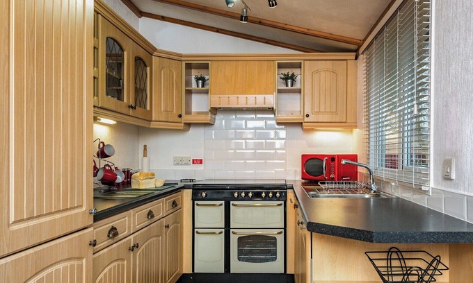 Carnforth Ski Chalet | This traditional two bedroom holiday home one row back from the lake, boasts partial lake views.