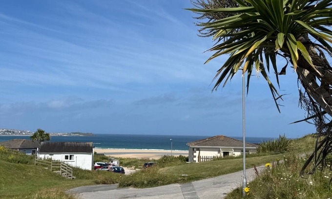 Hayle Ski Chalet | Treville soaks up the sun, which can be enjoyed from the deck with sea views.