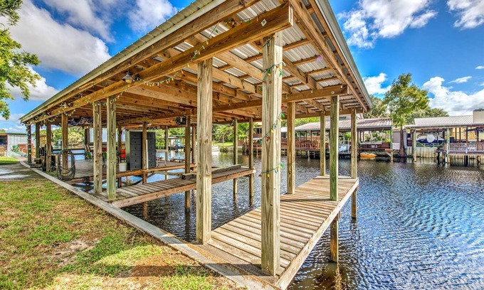 Fedhaven House | Tropical Lake House with waterfront tiki bar and wrap around porch