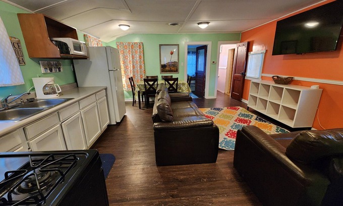 Monticello Cabin | Two Bedroom Cabin - Street & Pool View - Two bedroom cabin conveniently located at Outrigger Resort, right down the road from Indiana Beach Amusement Park! This 600 sq ft classic cabin offers two (2) queen beds and two (2) futons to sleep six (6)! Am