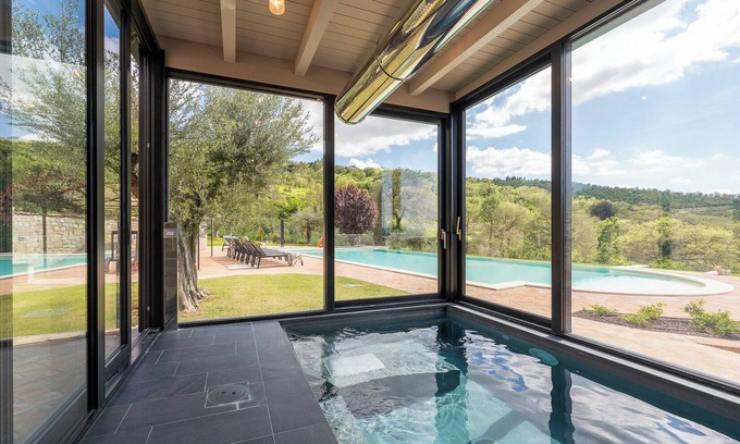 Torricella Villa | Villa Lago is set against a hillside of luscious greenery olive groves