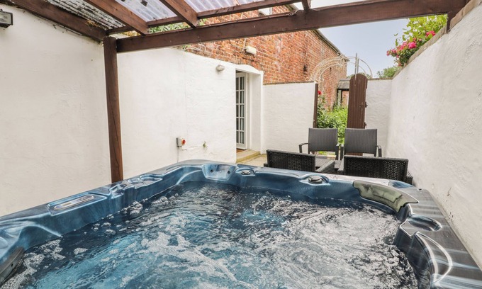 Hendrerwydd Cottage | WALLED GARDEN COTTAGE, pet friendly, with hot tub in Denbigh