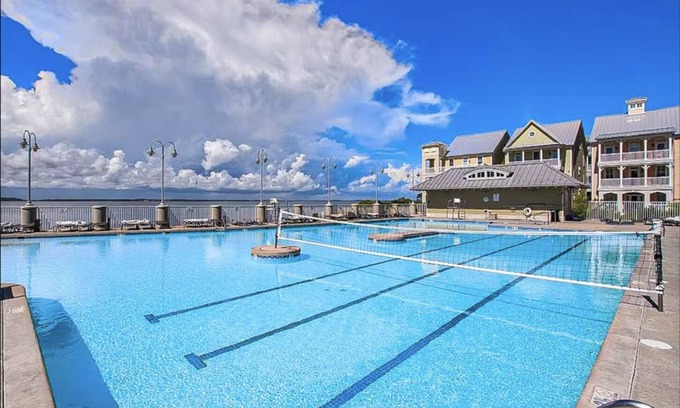 Sunset Island Condo | Waterfront condo with balcony, fireplace, AC, W/D, WiFi, indoor & outdoor pools