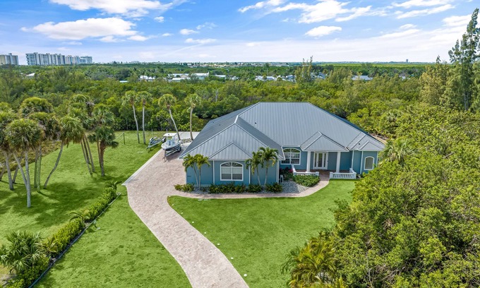 Fort Pierce Shores House | Waterfront home/steps to the beach/private dock/heated pool/spa