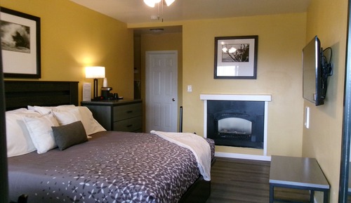 King Bedroom with Fireplace: Partial Ocean View