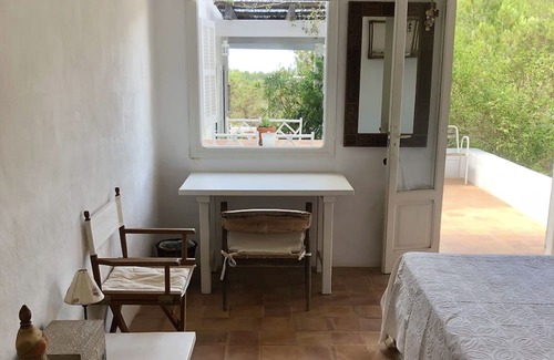 Es Cap de Barbaria House | Formentera. Room immersed in the woods with sea view.