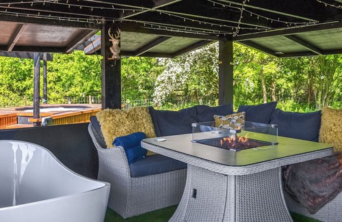 Storwood Cottage | We just love the outside entertainment area with a bath for two, table top fire pit and large Smart