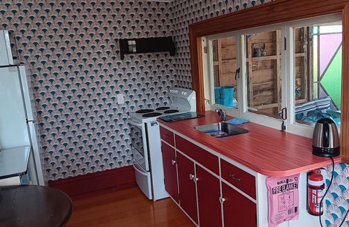 Port Waikato Cottage | Cosy retreat at Port Waikato with amazing sunsets and river views