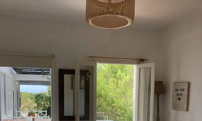 Es Cap de Barbaria House | Formentera. Room immersed in the woods with sea view.